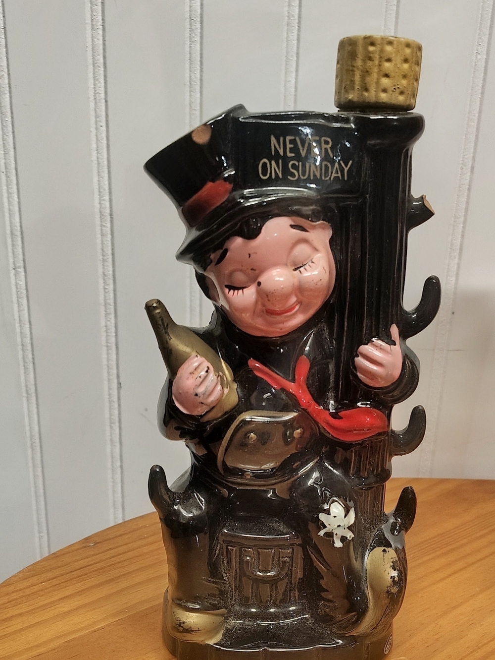VINTAGE Ceramic novelty decanter titled 'Never on Sunday'